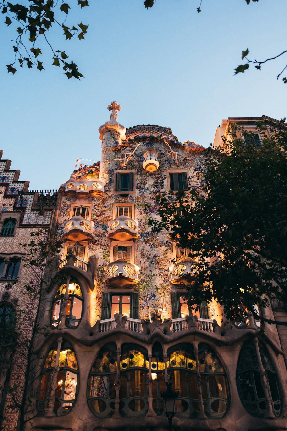 The mosaic facade of Casa Batlló in Barcelona at dusk