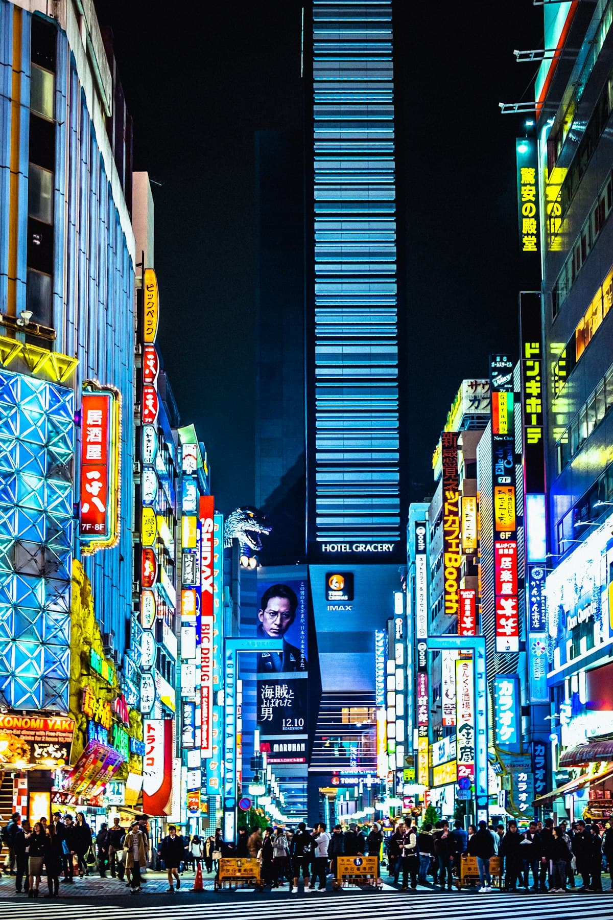 A Shinjuku street in Tokyo at night, lit by neon signs